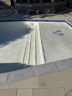 Sun shelf and entry steps with blue waterline tile after resurfacing
