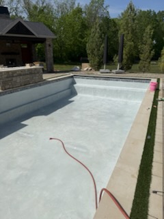 Pool being filled after fresh plaster application